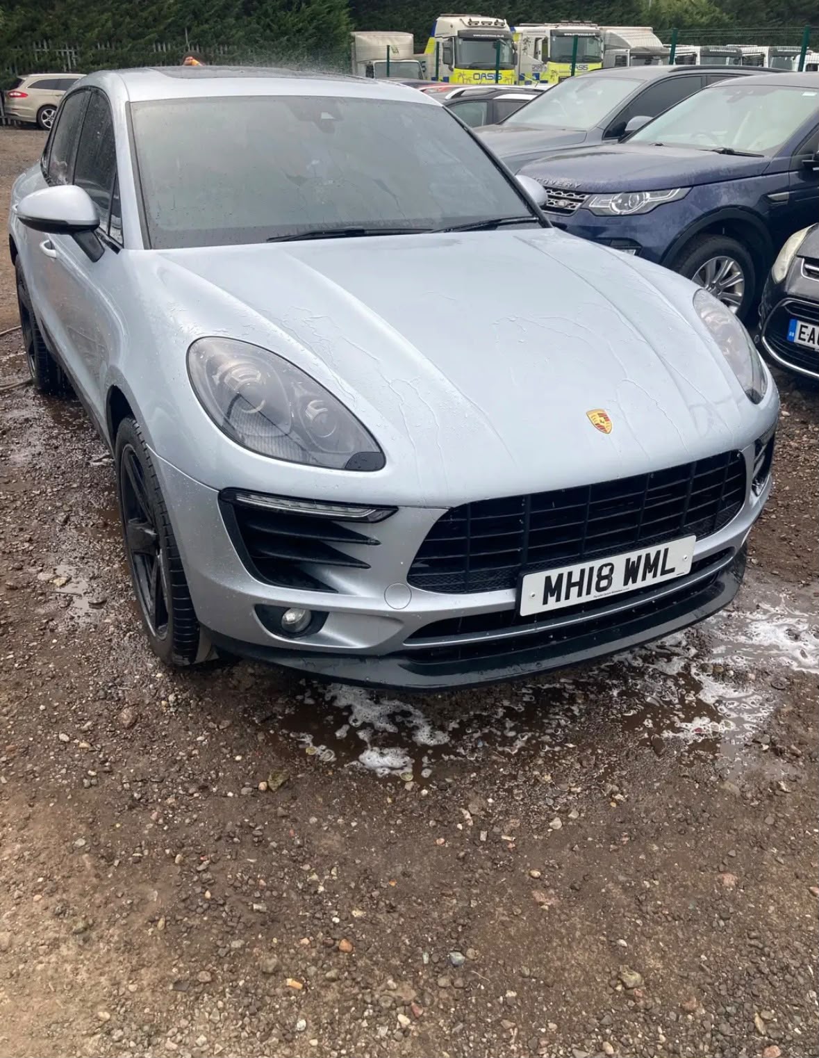 Silver Porsche Macan being washed